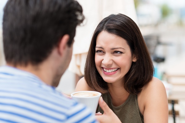 Happy couple having a great time talking over a cup of coffee